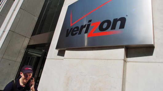 A pedestrian talks on his cell phone while walking past the Verizon Communications Inc. headquarters in New York.